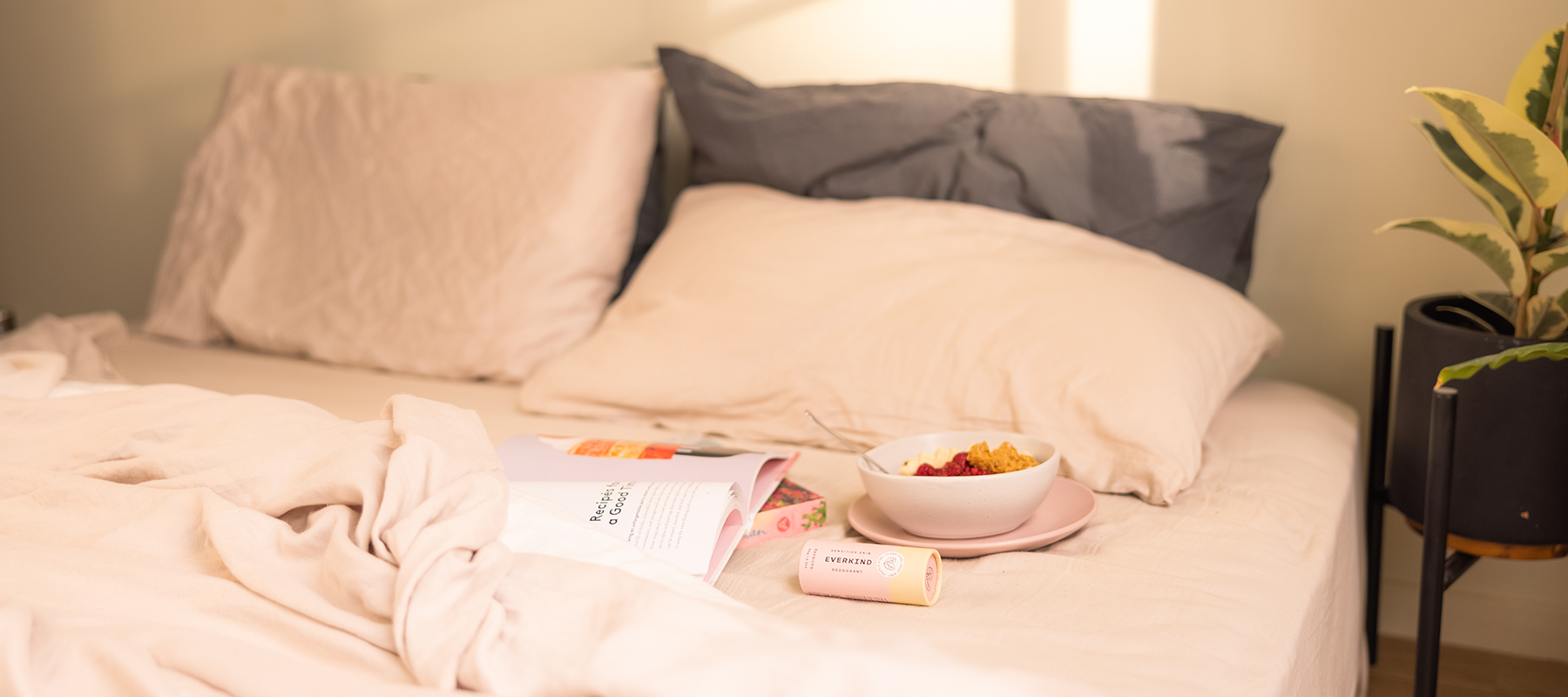 Photo linen bed with health breakfast, selfcare journal, and Everkind organic deodorant.
