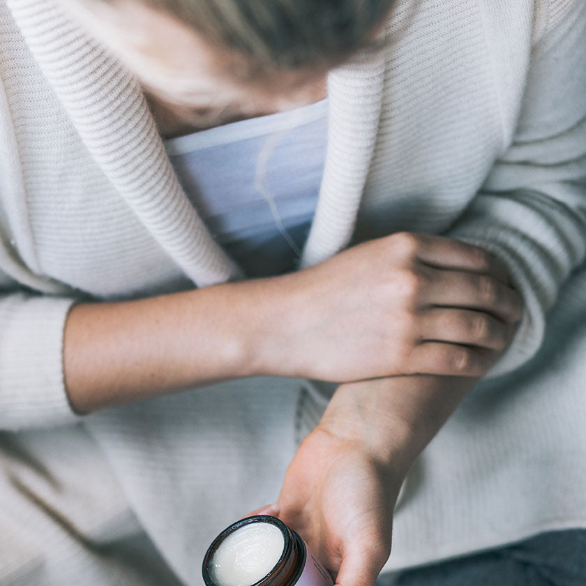 Woman caring for her body with Everkind Organic Body Balm Oils. Fine fragrance body moisturisers made from purely certified organic ingredients.. 