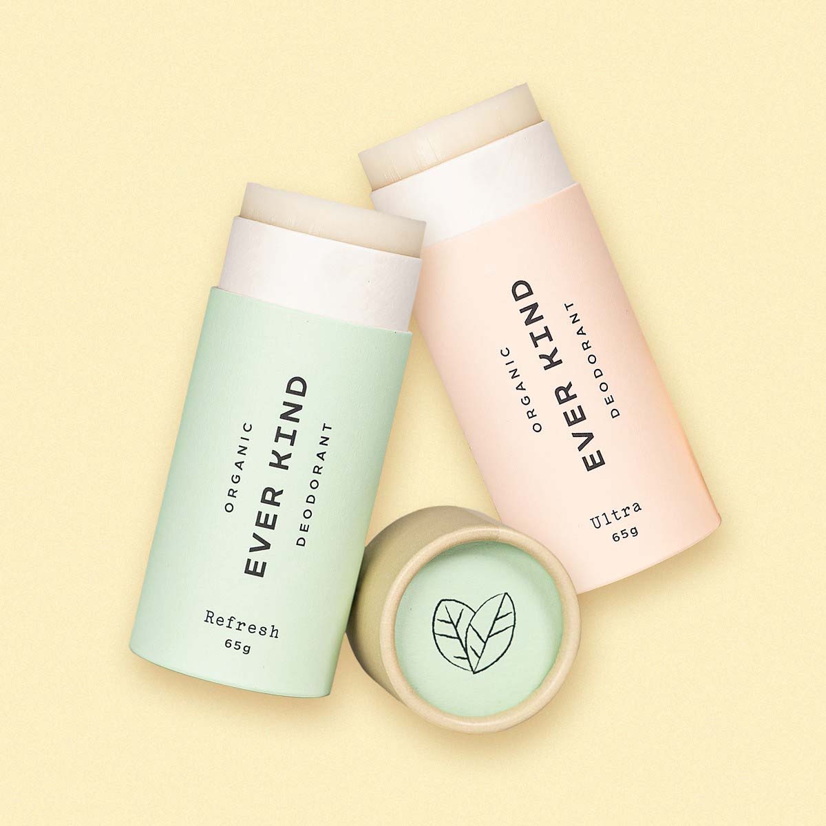 Everkind's Active Women's Duo, featuring Ultra and Refresh natural deodorants in pastel pink and green compostable paper packaging, on a soft yellow background.