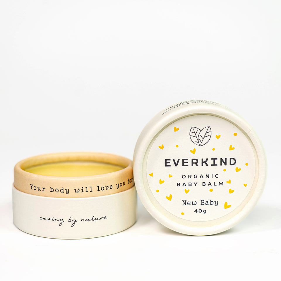 Photo of Everkind's New Baby massage balm. Unscented and packaged in a purely paper home compostable jar.