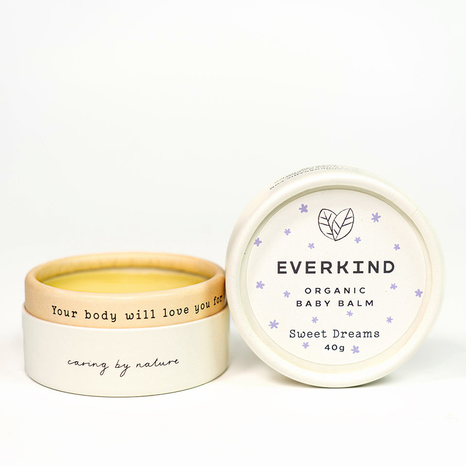 Photo of Everkind&#39;s baby massage cream called Sweet Dreams. Scented with chamomile and lavender and packaged in a purely paper home compostable jar.