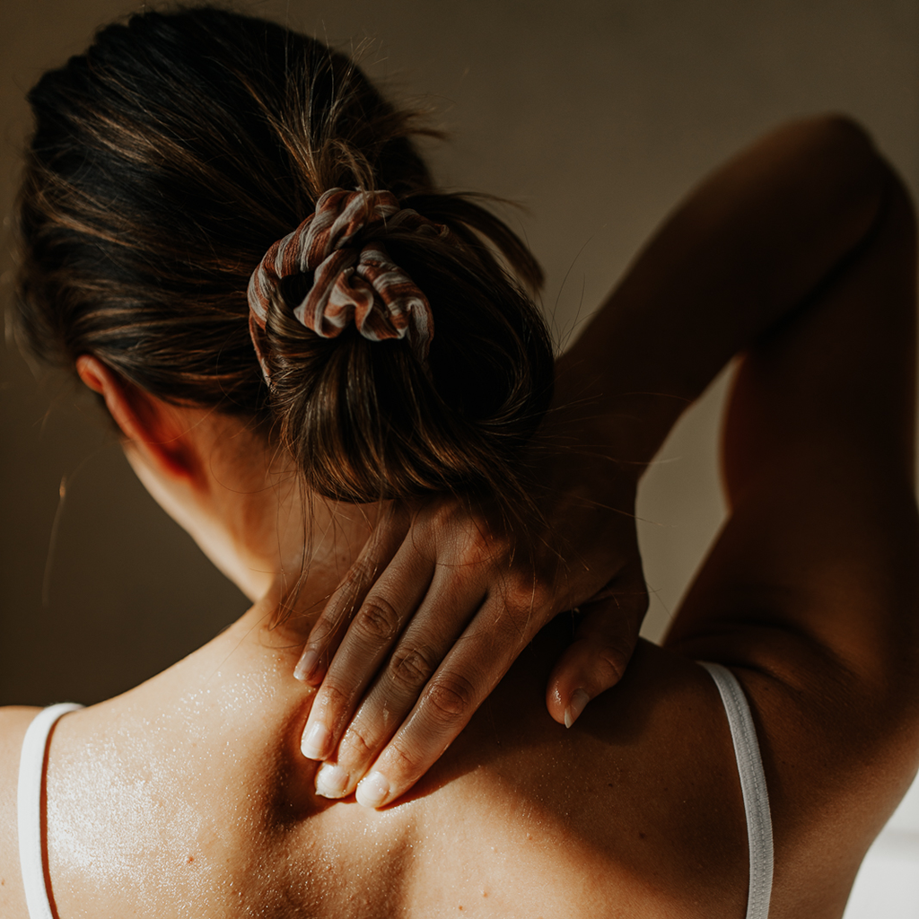 Women soaking in sunshine, using Everkind Organic Body Balm to moisturise her skin and soothe her mind. These fine fragrance body balms are bliss for body and mind.