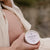 Photo of pregnant woman holding Everkind's Mama Balm Bloom. This is the only massage balm for mothers packaged in a purely paper jar. Bllom is scented with pure organic lavender, which is the most relaxing scent on earth.